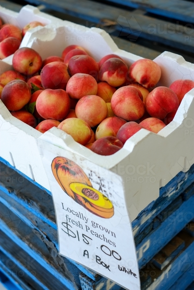 A box of fresh peaches for sale at Bilpin Fruit Bowl - Australian Stock Image