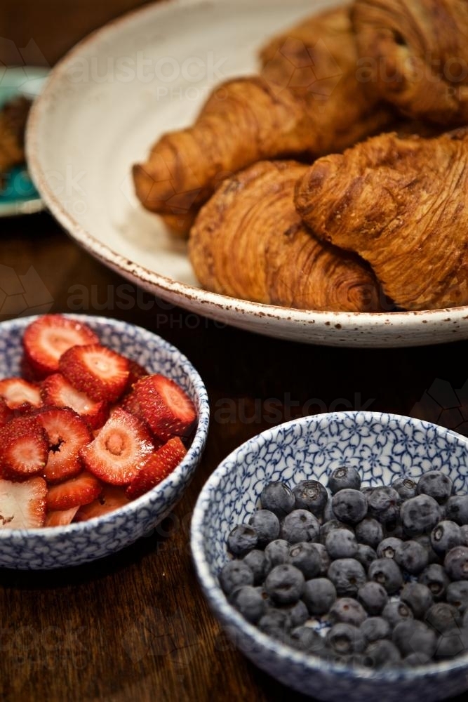A breakfast selection of croissants, strawberries and blueberries - Australian Stock Image