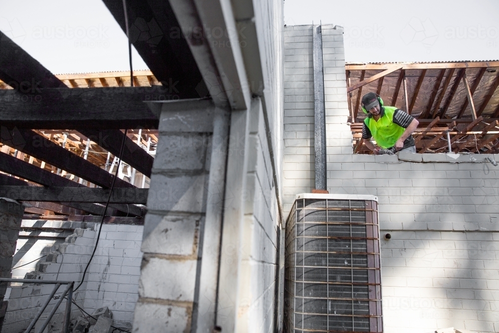 A builder working at height on a construction site. - Australian Stock Image