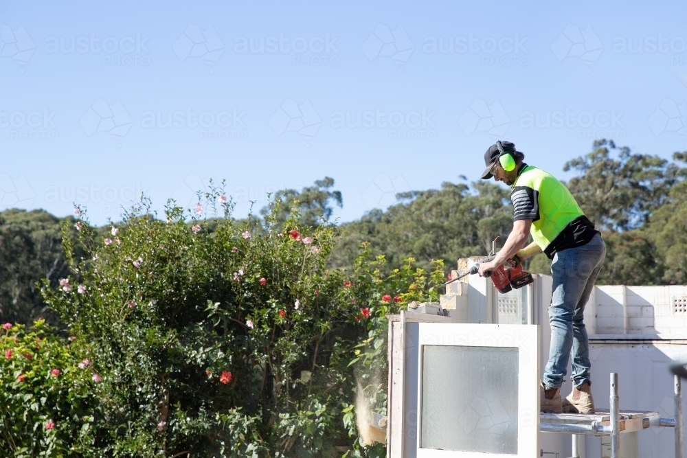 A builder working at height on on construction - Australian Stock Image