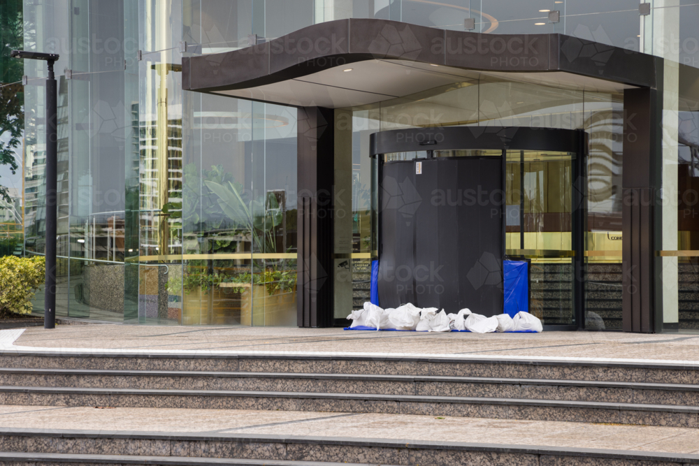 A building entrance is sandbagged and sealed in preparation for tropical cyclone Alfred in Brisbane - Australian Stock Image