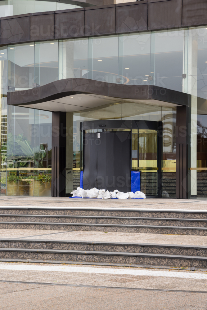 A building entrance is sandbagged and sealed in preparation for tropical cyclone Alfred in Brisbane - Australian Stock Image