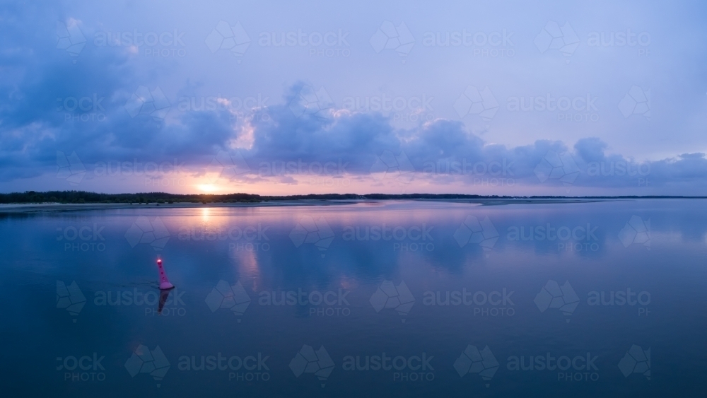 A calm serene sunrise over Bribie Island and Pumicestone Passage, Sunshine Coast - Australian Stock Image