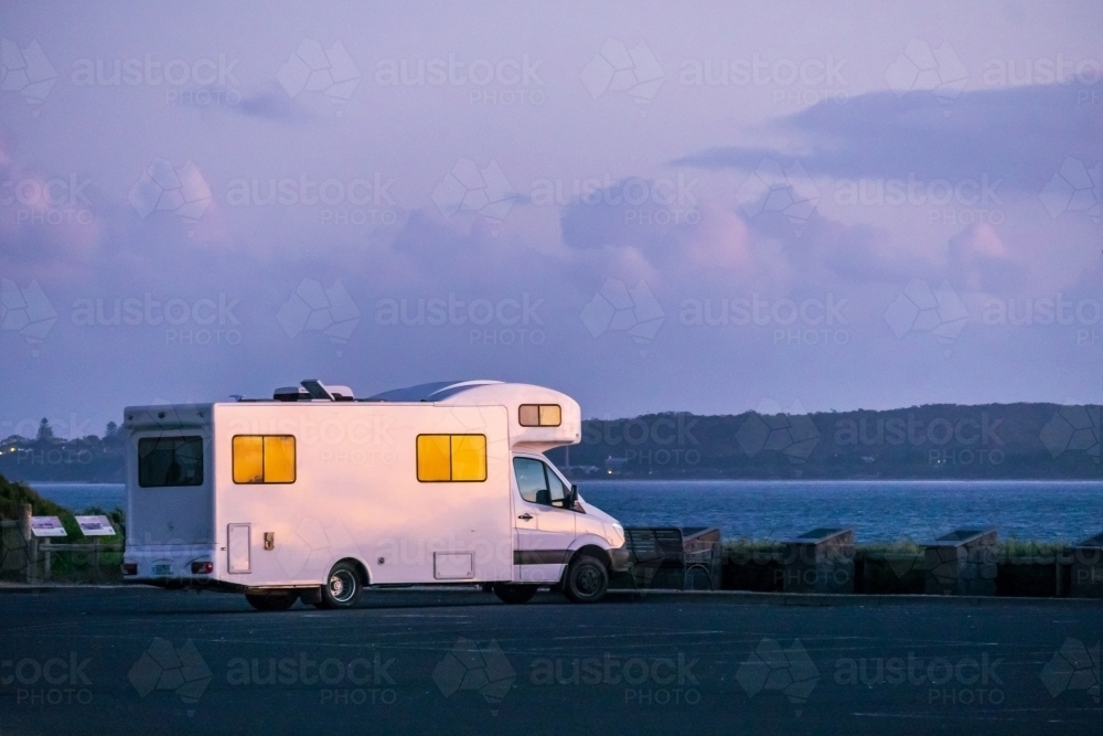A campervan parked at an ocean lookout at twilight - Australian Stock Image