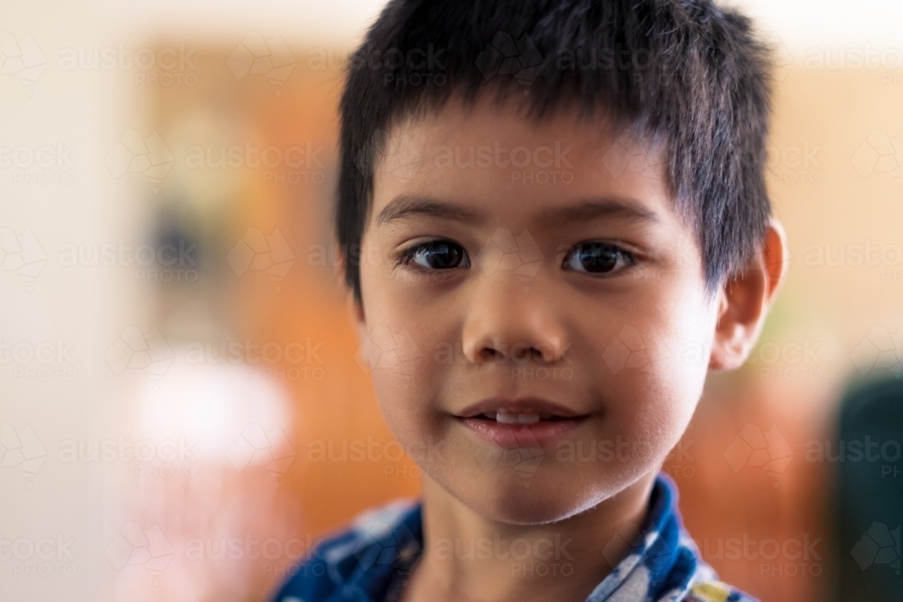 a candid smile from a boy in his pyjamas - Australian Stock Image