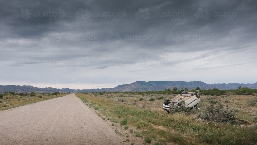 Image of A car rolled over after having an accident on a rural road ...