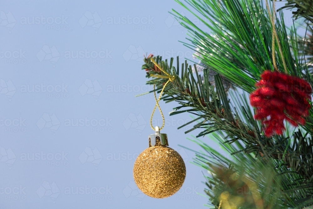 A Christmas tree is decorated with baubles.  A closeup with shallof dof and copy space. - Australian Stock Image