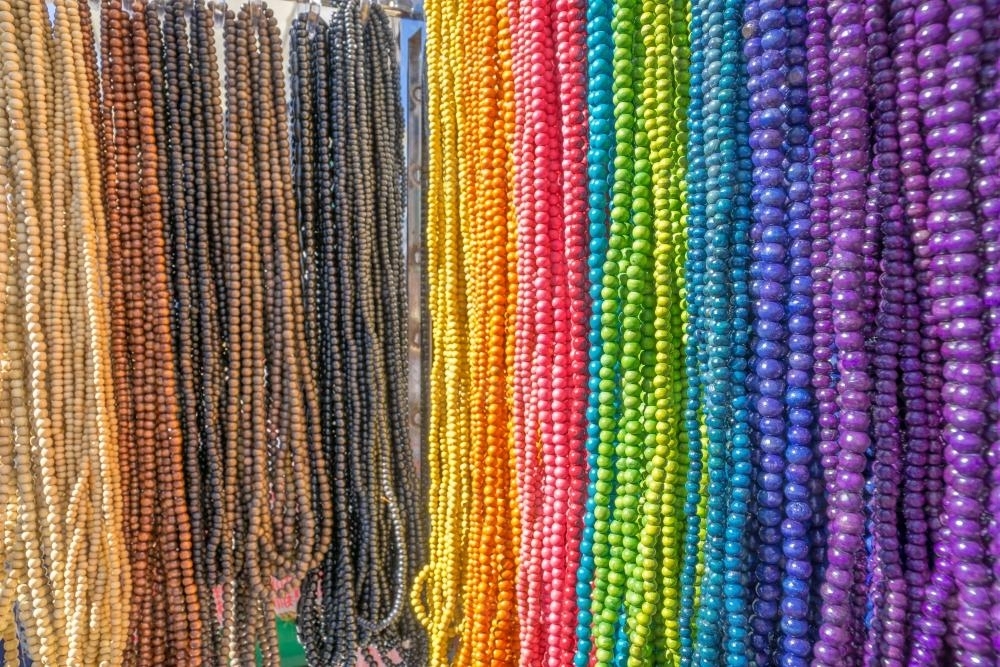 A close up of a rack of rainbow coloured beads - Australian Stock Image