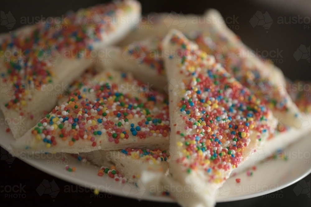 a Close up plate of fairy bread, bread buttered and then sprinkled with sprinkles - Australian Stock Image