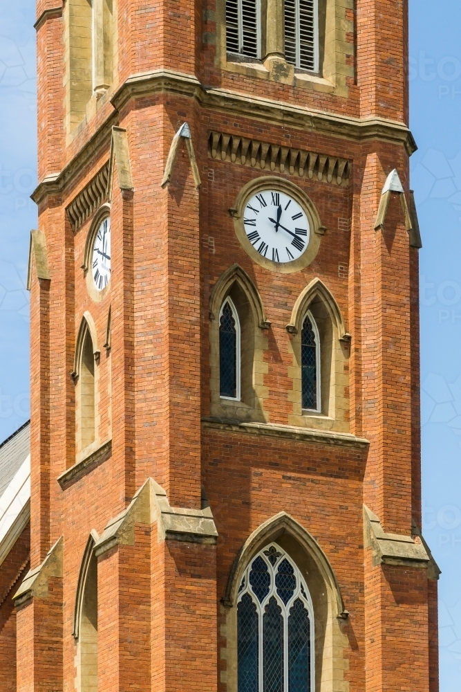 A close up section of a brick clock tower - Australian Stock Image