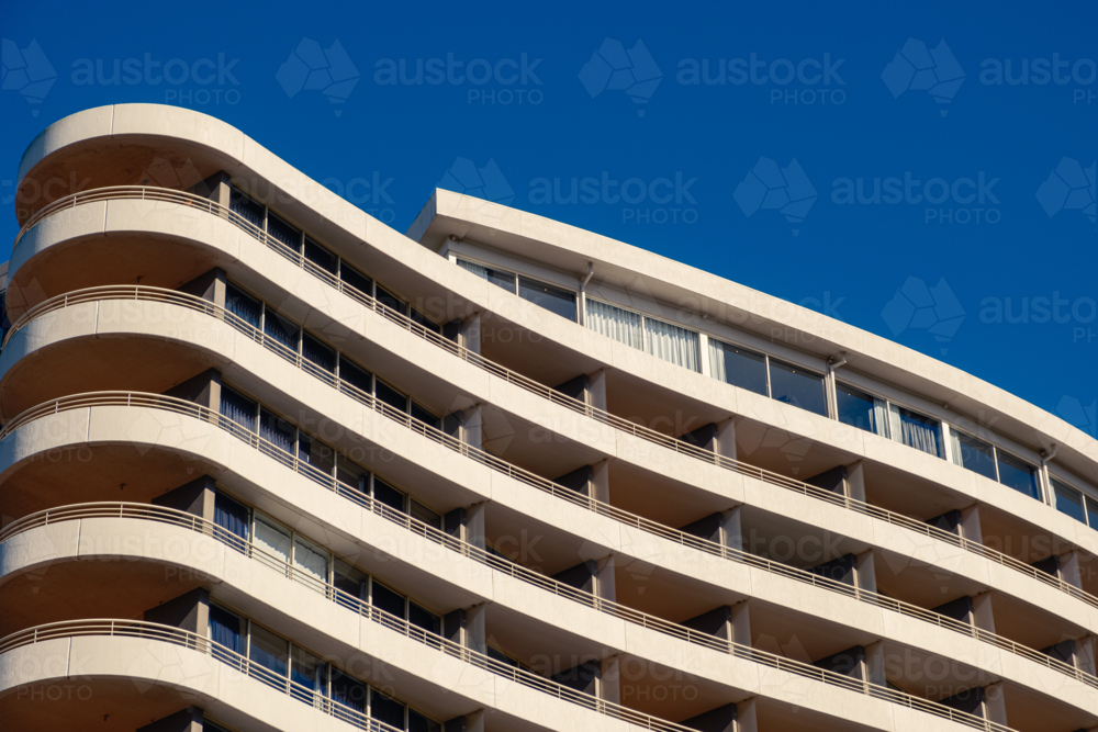 A closeup of an Apartment Building looking up from the footpath with Blue Sky - Australian Stock Image