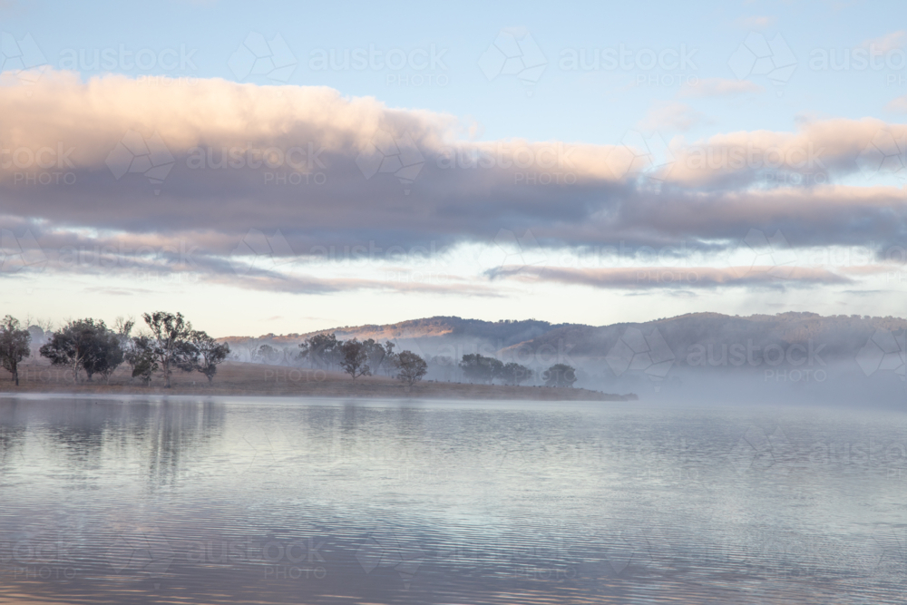 A cloudy sky over a country dam - Australian Stock Image