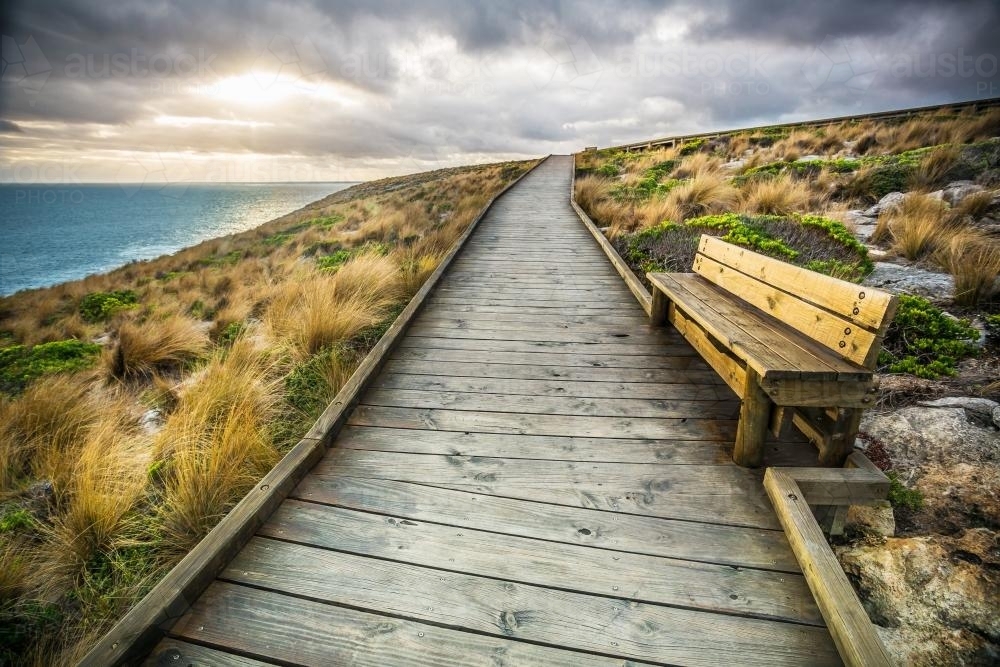 A coastal boardwalk leading over a hill - Australian Stock Image