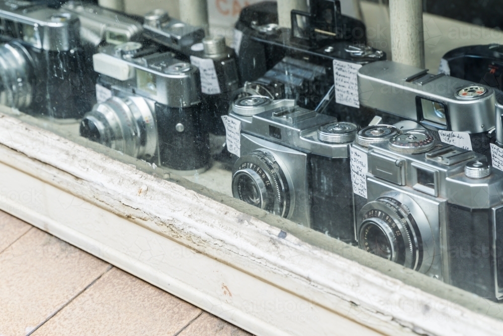 A collection of old cameras in a shop window - Australian Stock Image