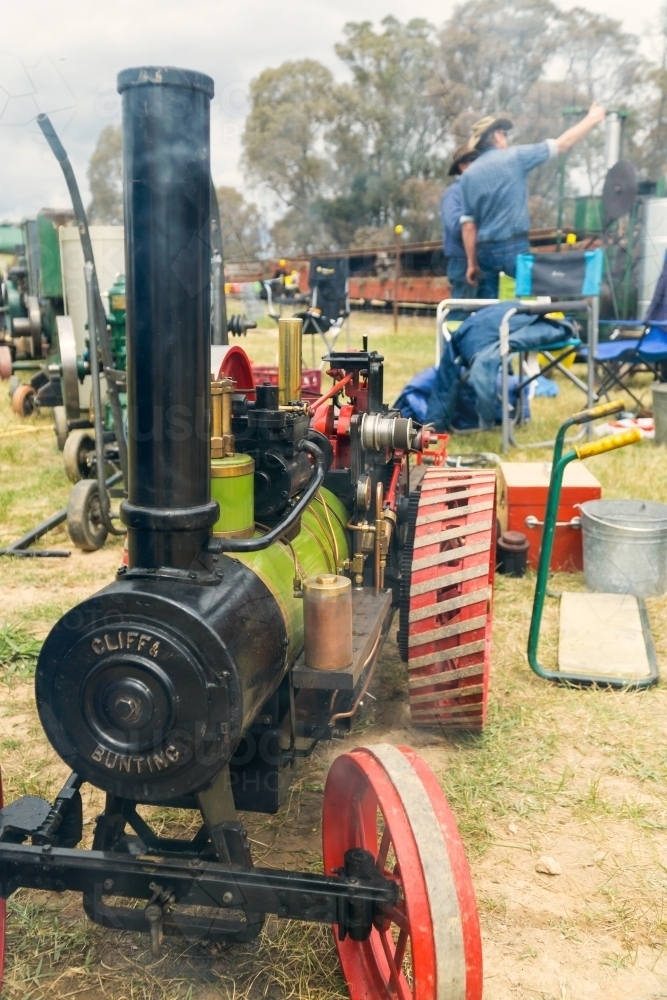 A colourful model traction engine puffing out smoke at machinery exhibition - Australian Stock Image