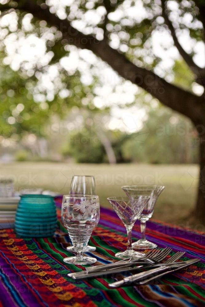 A colourful picnic table set under some trees in bushland - Australian Stock Image