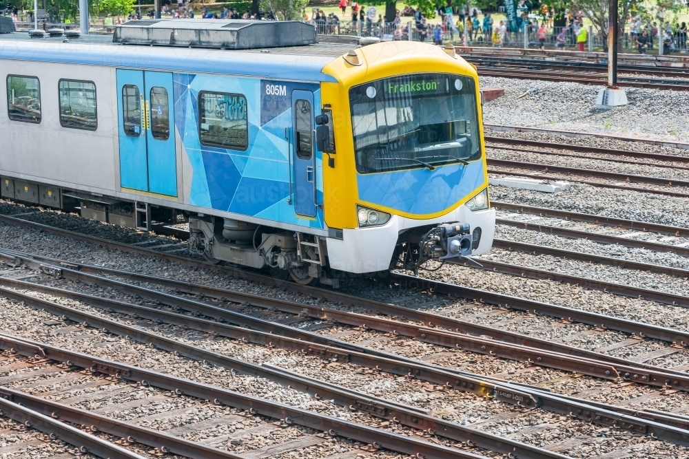 A commuter train running through a railway yard - Australian Stock Image