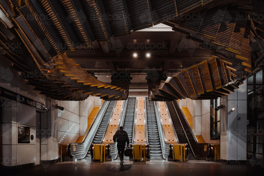 A commuter using the escalators at Wynyard Station - Australian Stock Image