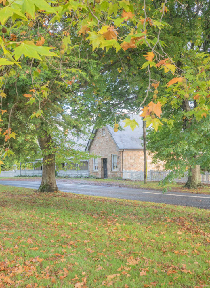 A country road, an old stone house and autumn foliage - Australian Stock Image