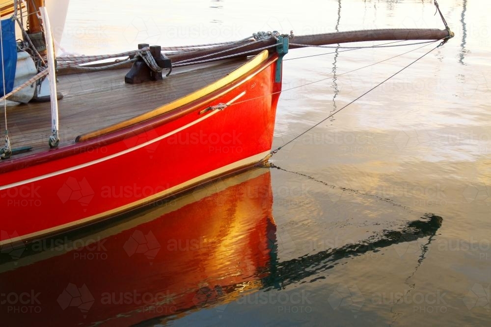 A couta boat and its reflection - Australian Stock Image