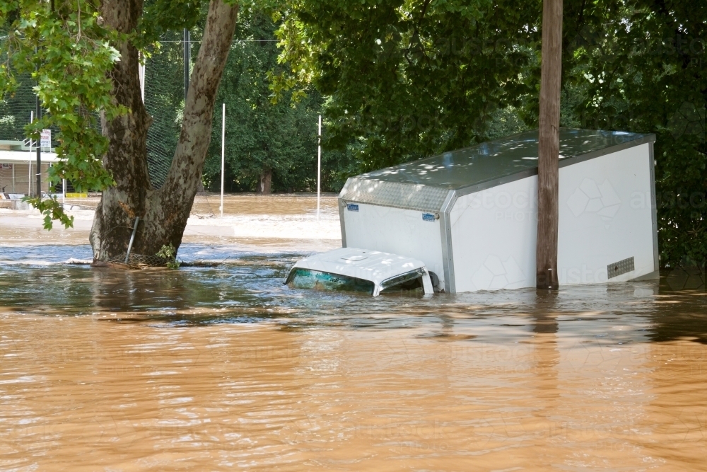 A covered in truck half submerged in flood waters - Australian Stock Image