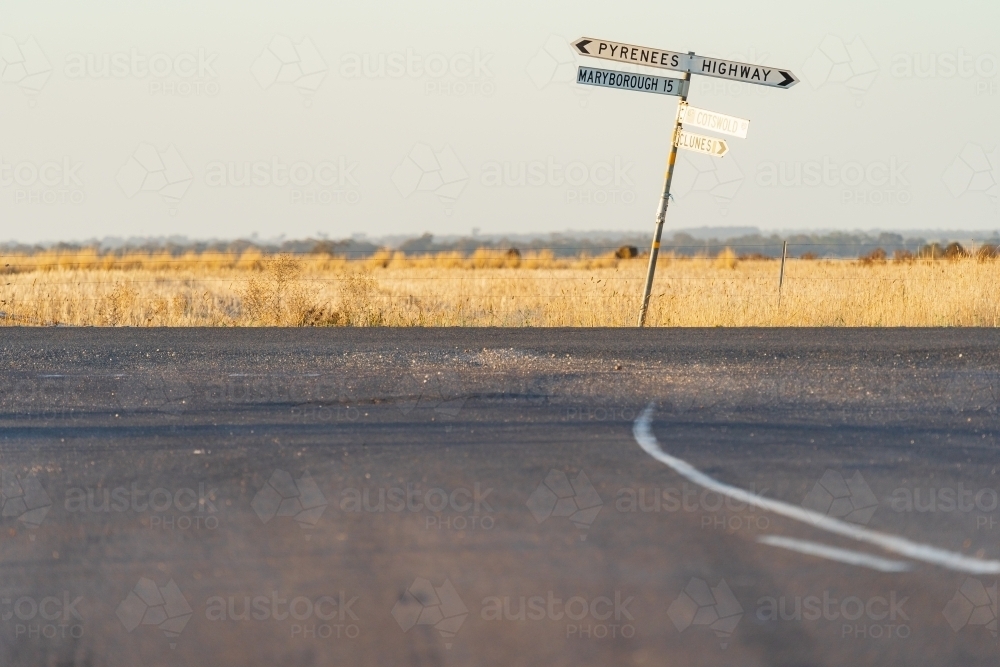 A crooked signpost on a roadside of a rural intersection - Australian Stock Image