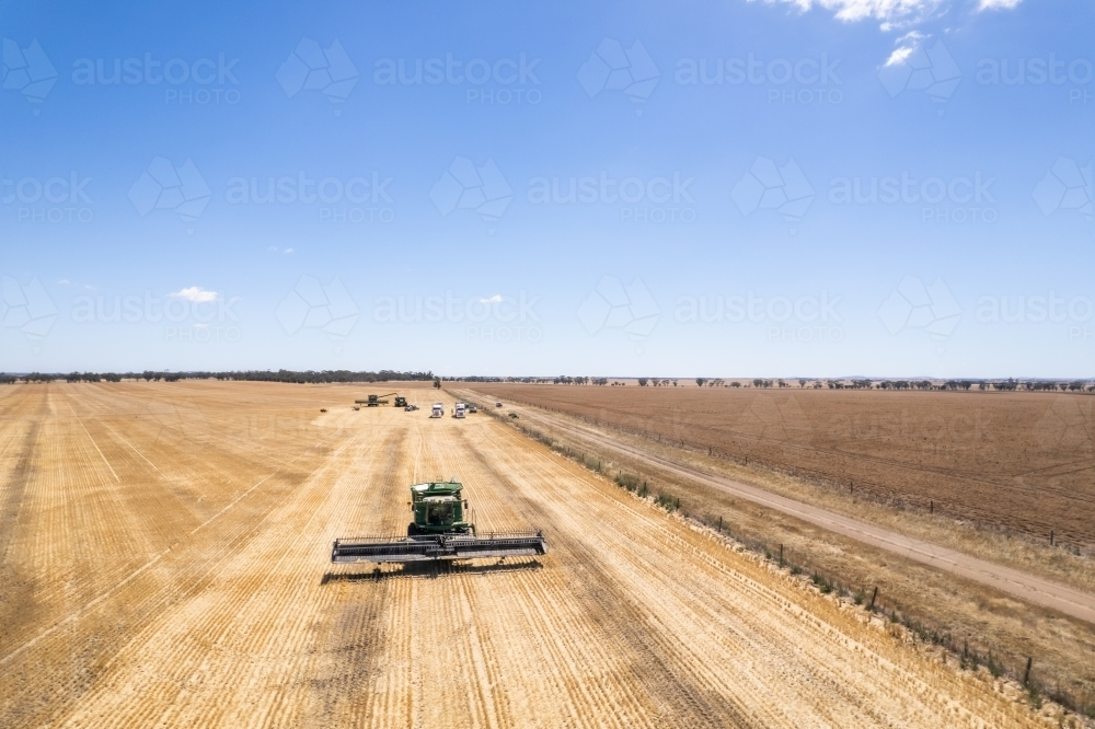 A crop harvester in the middle of farmland - Australian Stock Image