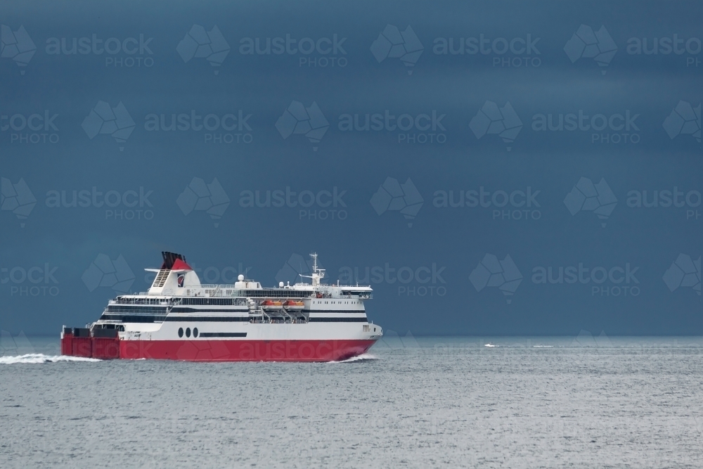 A cruise ship heading towards bad weather on the horizon - Australian Stock Image
