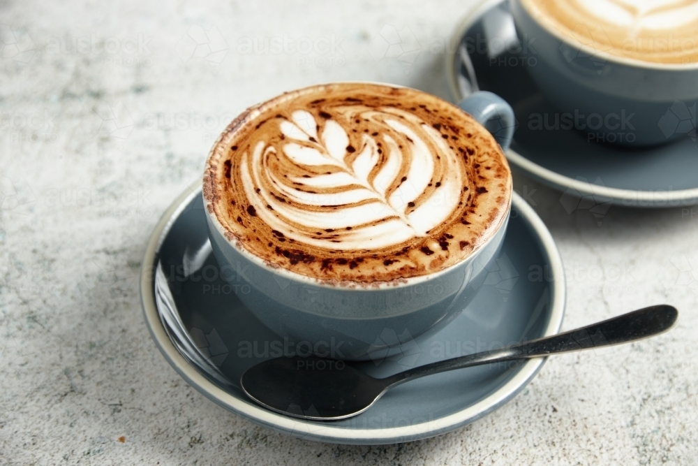 A cup of coffee with coffee art - Australian Stock Image