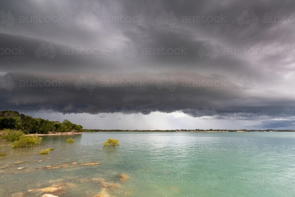 A dark shelf cloud approaches over the ocean - Australian Stock Image
