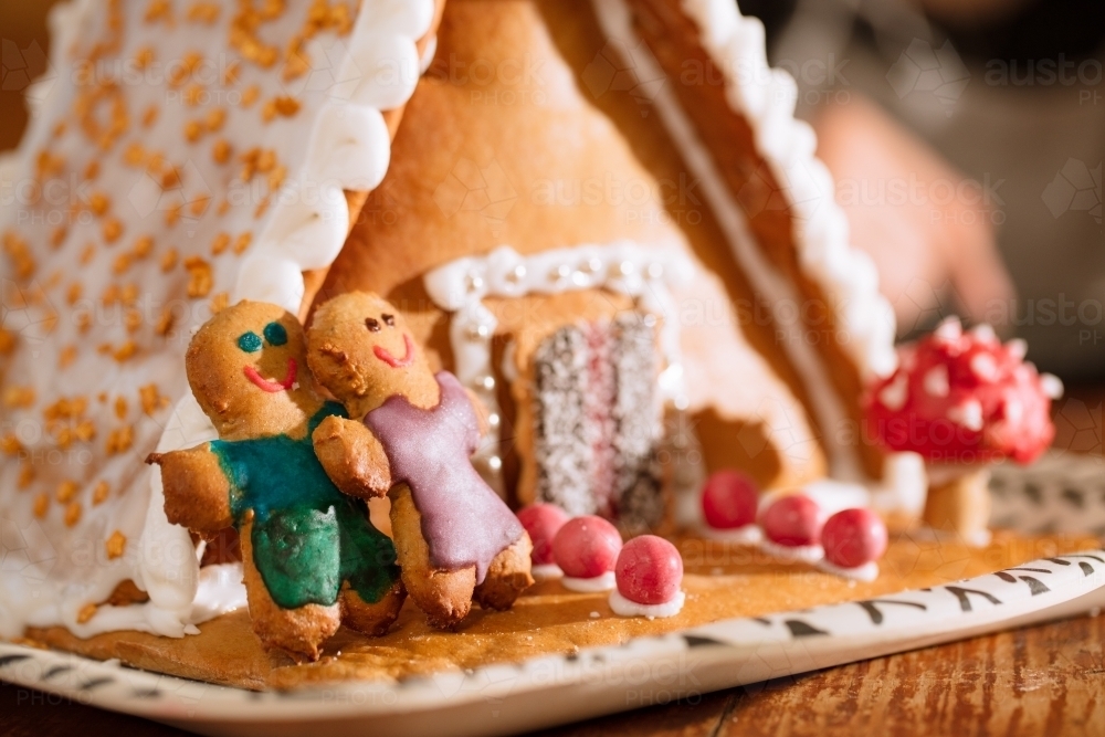 A decorated homemade gingerbread house with figurines - Australian Stock Image