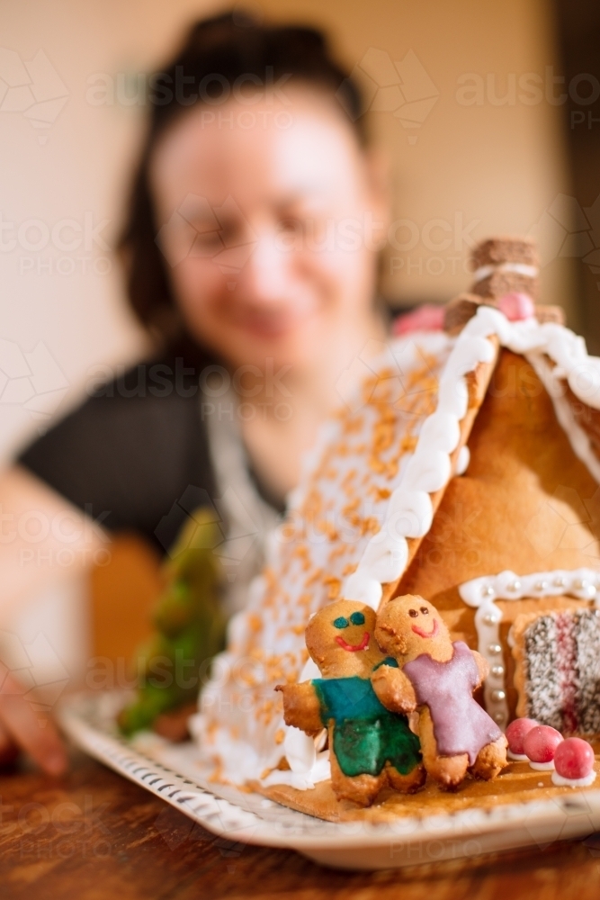 A decorated homemade gingerbread house with figurines - Australian Stock Image