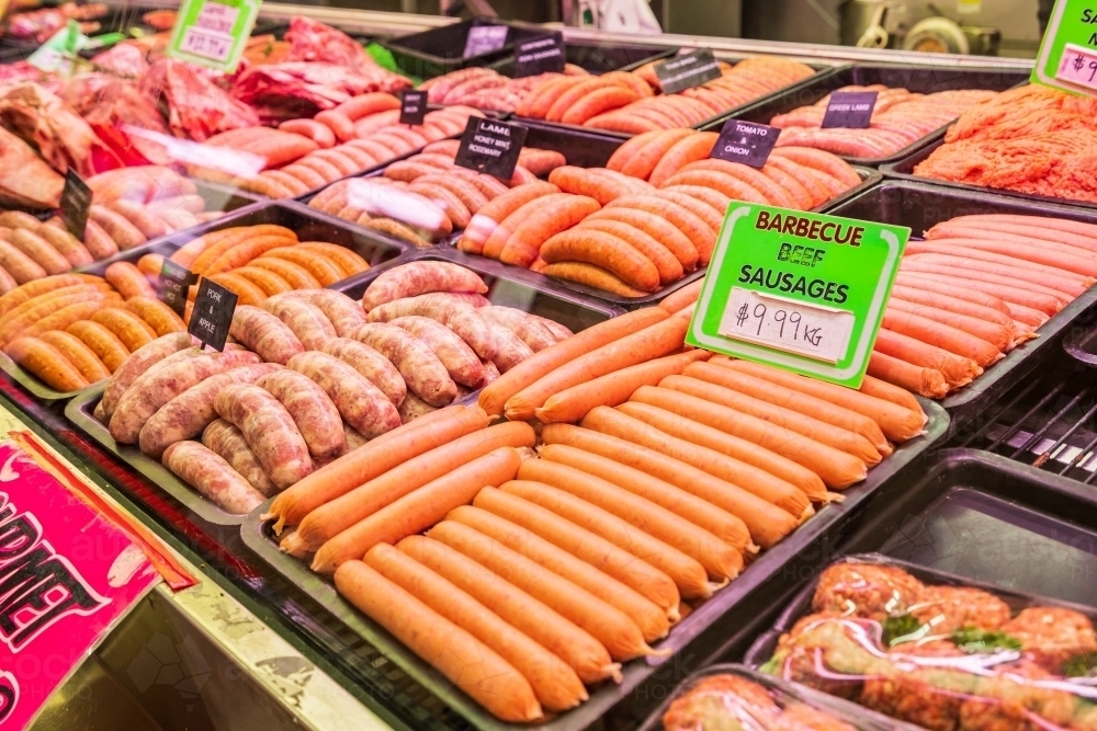 A display of sausages on trays in a market - Australian Stock Image