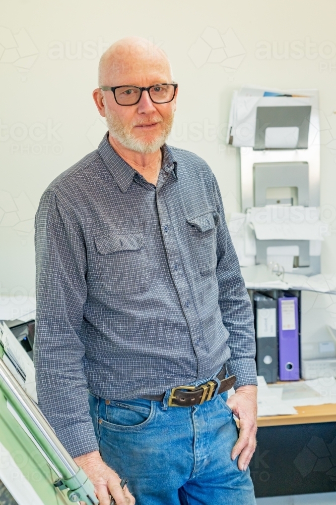 A draftsman standing proudly in front of his drawing board - Australian Stock Image