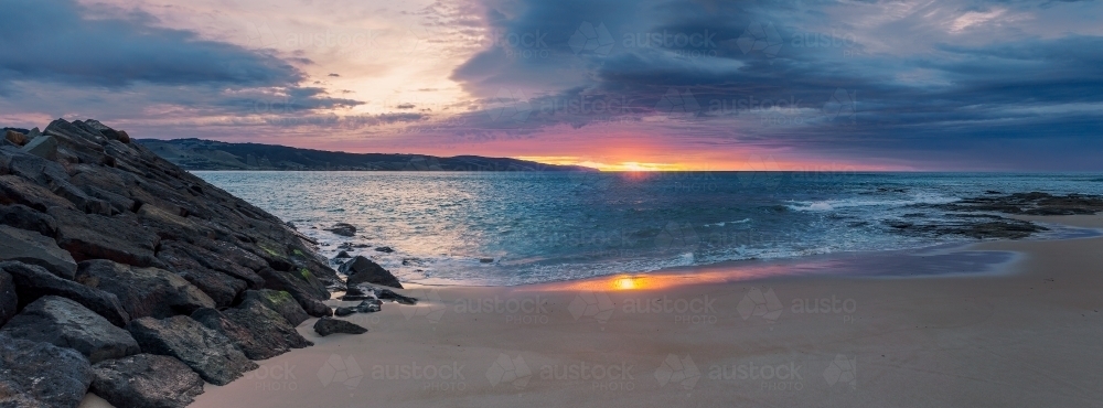 A dramatic sunrise over the waters of a small coastal bay - Australian Stock Image