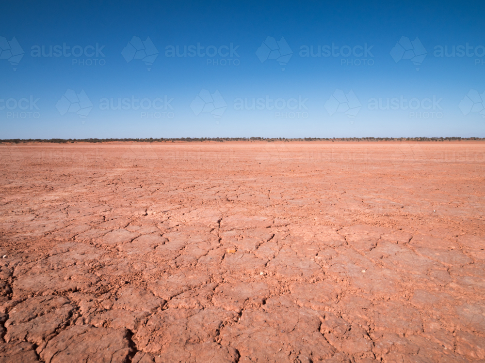 A dry mudplain and a blue sky in remote north-west New South Wales - Australian Stock Image