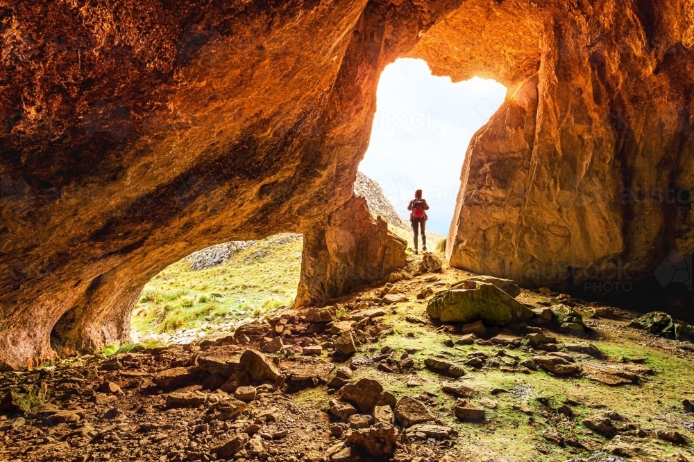 A female exploring caves in Australian wilderness - Australian Stock Image