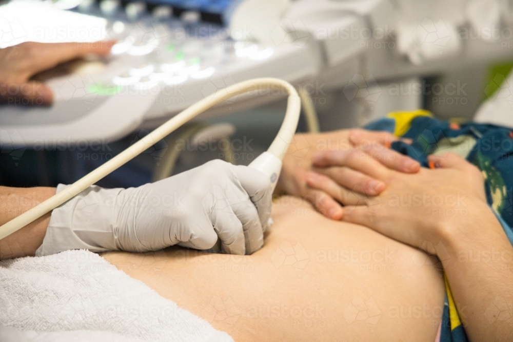 A female having an ultrasound performed on her abdomen - Australian Stock Image