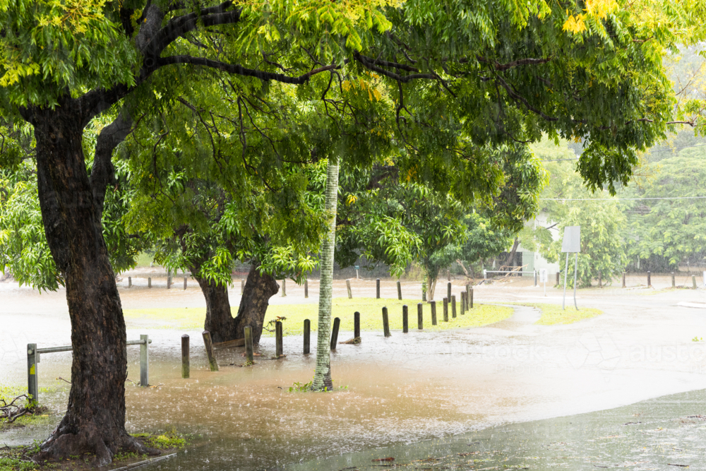 A flooded suburban street in suburban Brisbane during a major rain event - Australian Stock Image