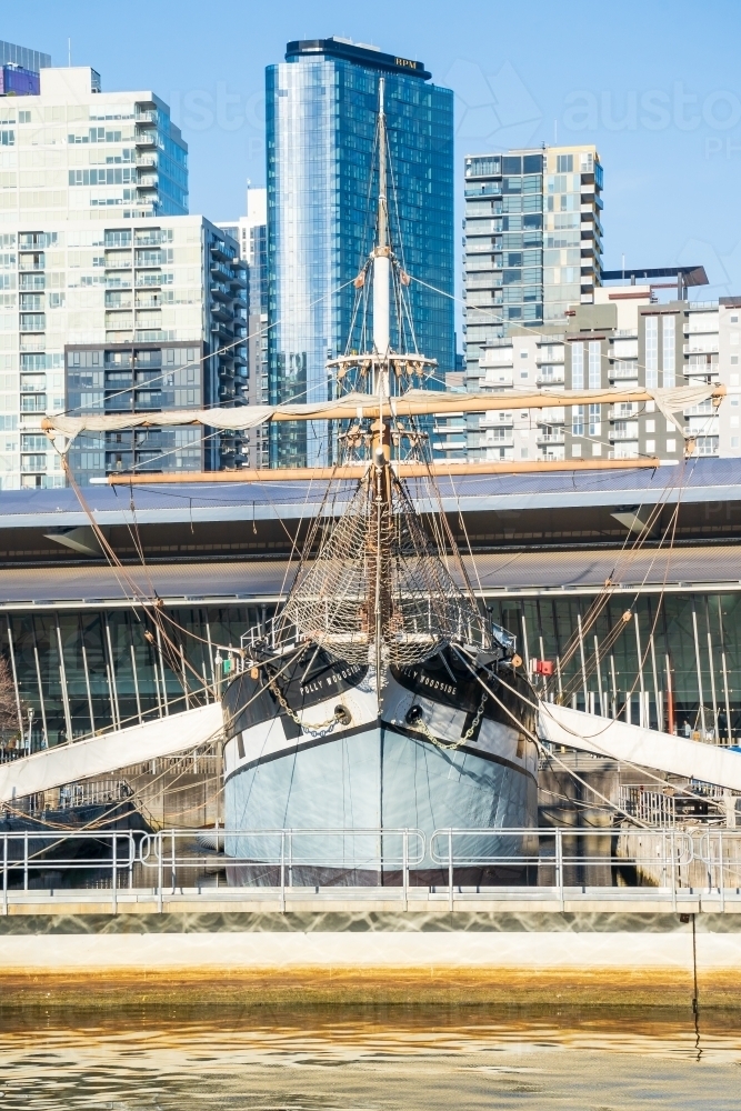 A front on view of the tall ship "Polly Woodside" docked in front of city buildings - Australian Stock Image