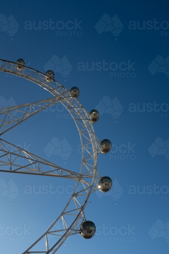 A generic large ferris wheel with gondolas to enjoy the view - Australian Stock Image