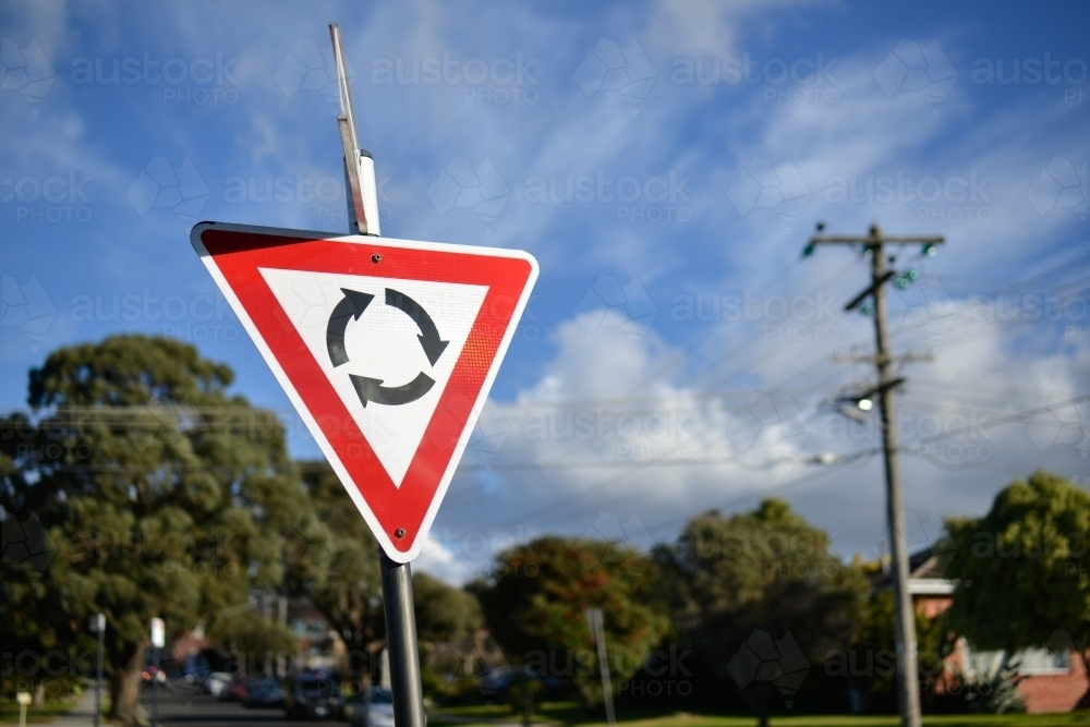 A give way at the roundabout street sign in the sun - Australian Stock Image