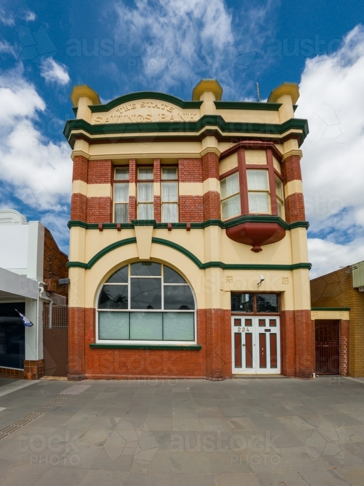 Image of A grand two storey historic building set back from the street