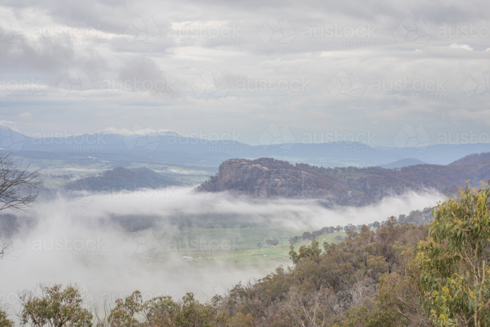 A granite monolith on a misty morning in the country - Australian Stock Image