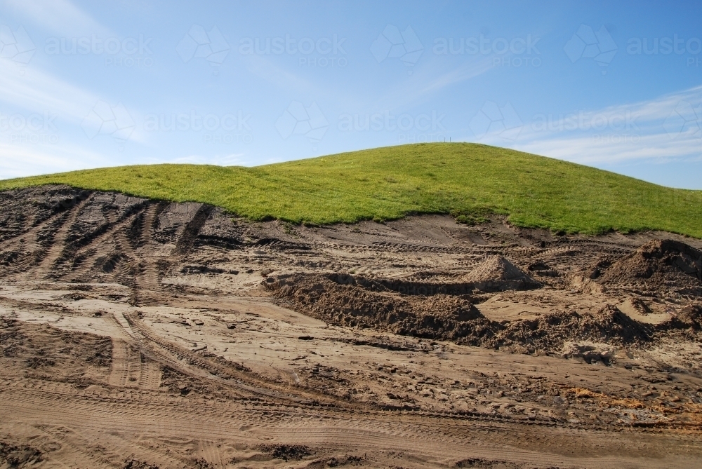 A grassy piece of land that has been excavated during construction works - Australian Stock Image