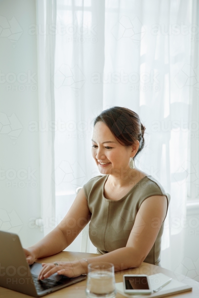 A happy career entrepreneur working from home - Australian Stock Image