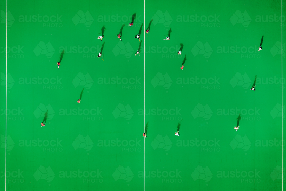 A hockey game on the green court at Kyeemagh. - Australian Stock Image