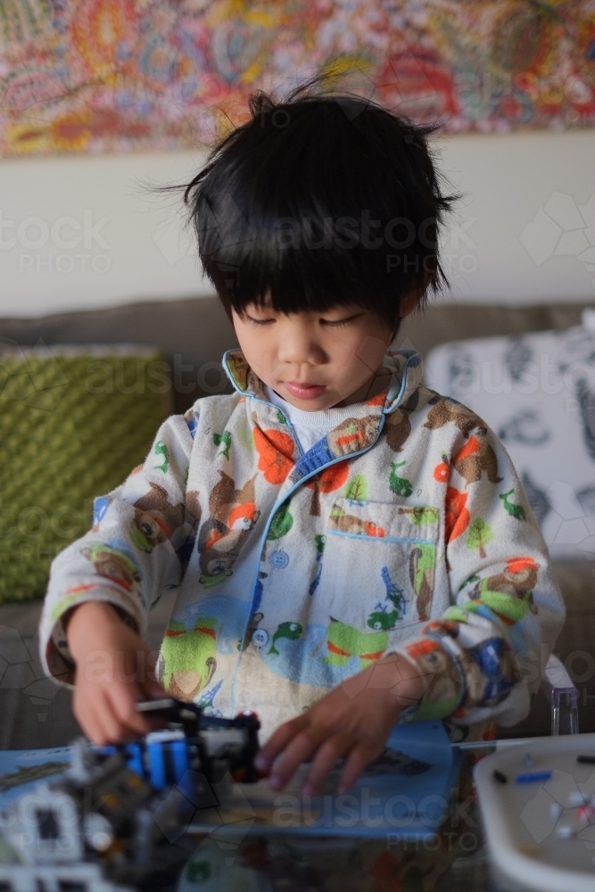 a kid building a Lego piece - Australian Stock Image