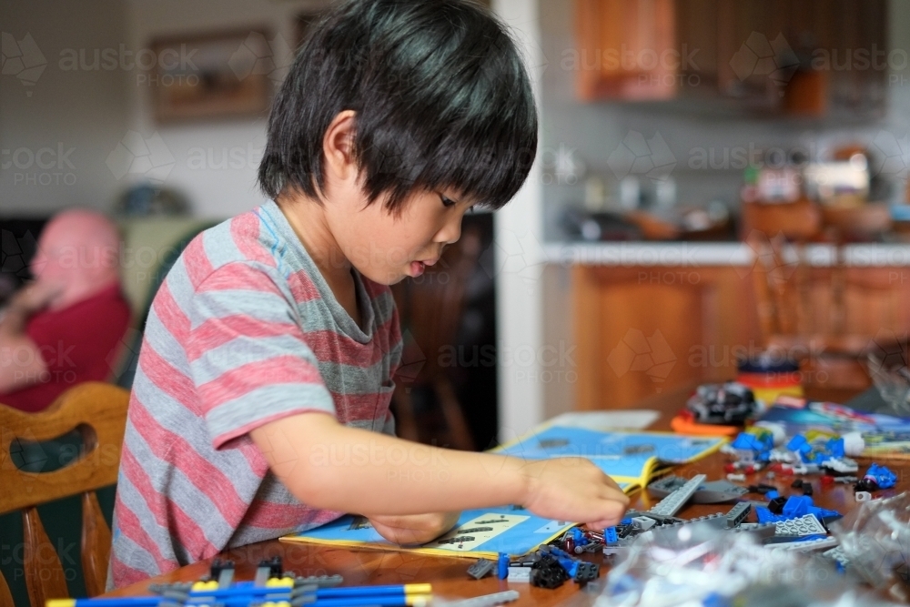 a kid building a Lego piece - Australian Stock Image