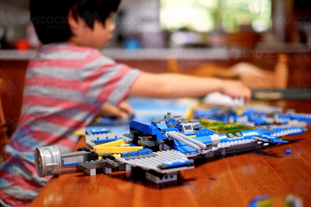 a kid building a Lego piece - Australian Stock Image